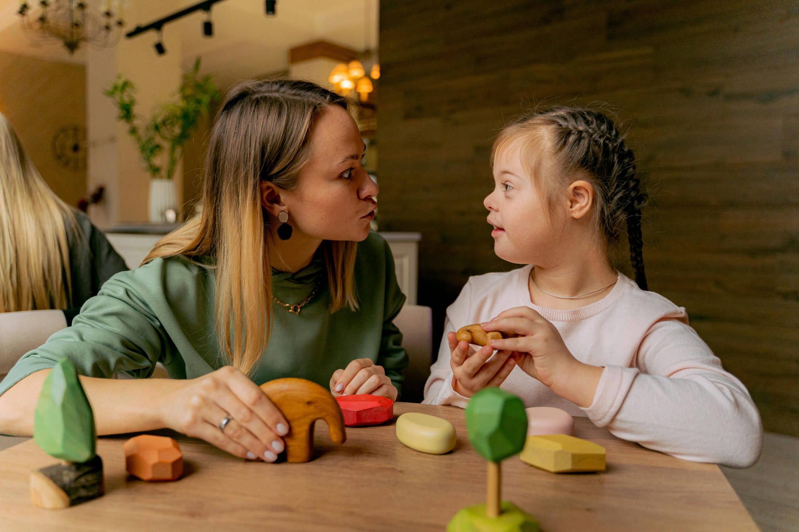 Support worker engaging with a child in NDIS care, showcasing the importance of personal care and support.