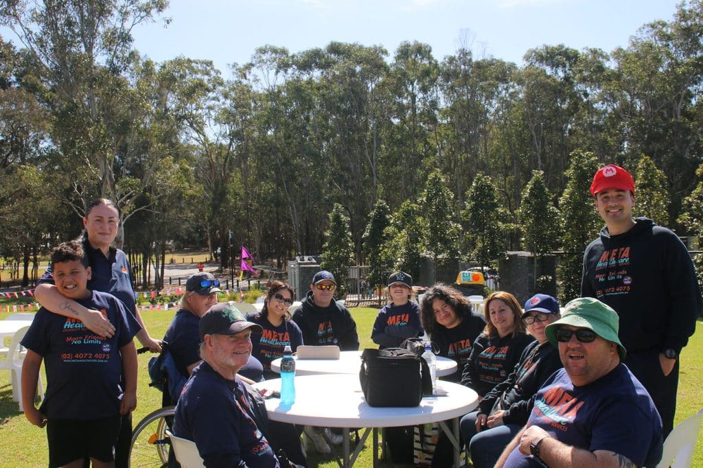 A group of people enjoying a community event in a park.