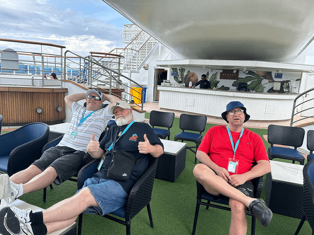 three friends enjoying leisure time on a cruise ship deck