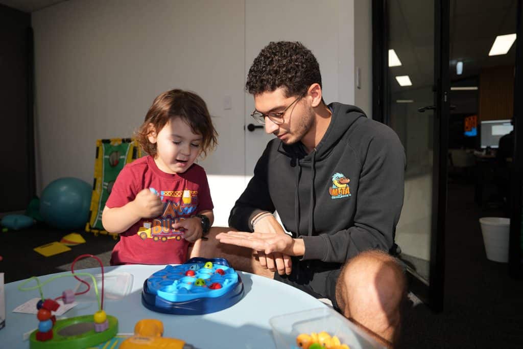 Meta Healthcare therapist supporting a child during a play-based developmental activity